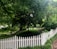 A well-maintained wooden fence surrounding a lush green garden.