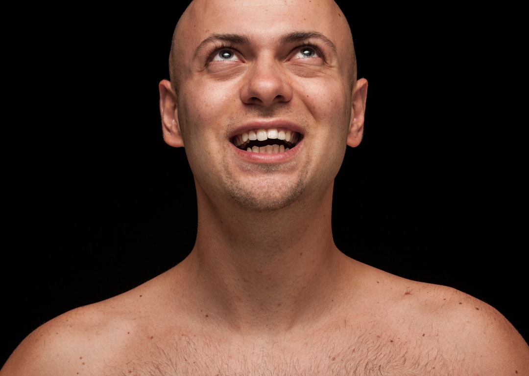 topless man with black background