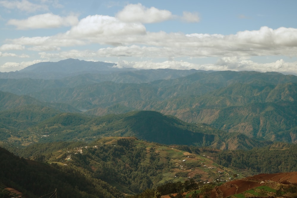 green and brown mountains under white clouds during daytime