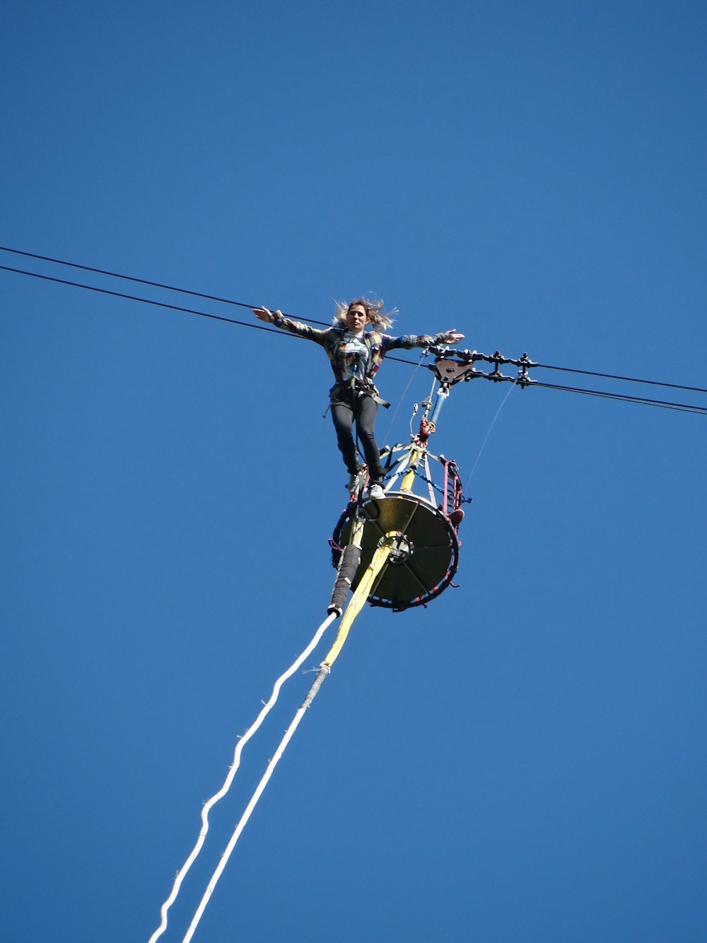 yellow and black helicopter in mid air under blue sky during daytime