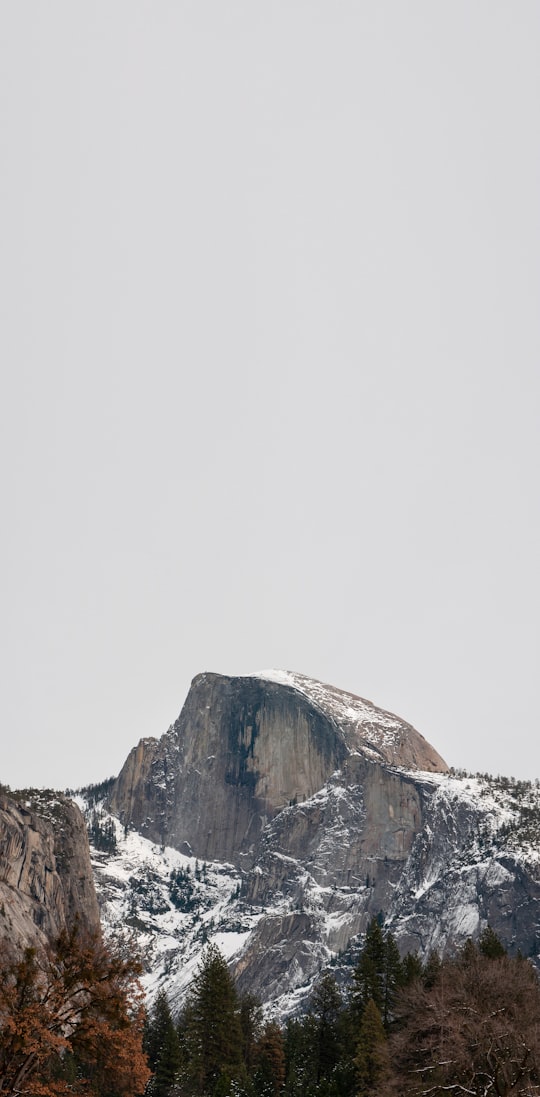 snow covered mountain under white sky during daytime in Yosemite National Park, Half Dome United States