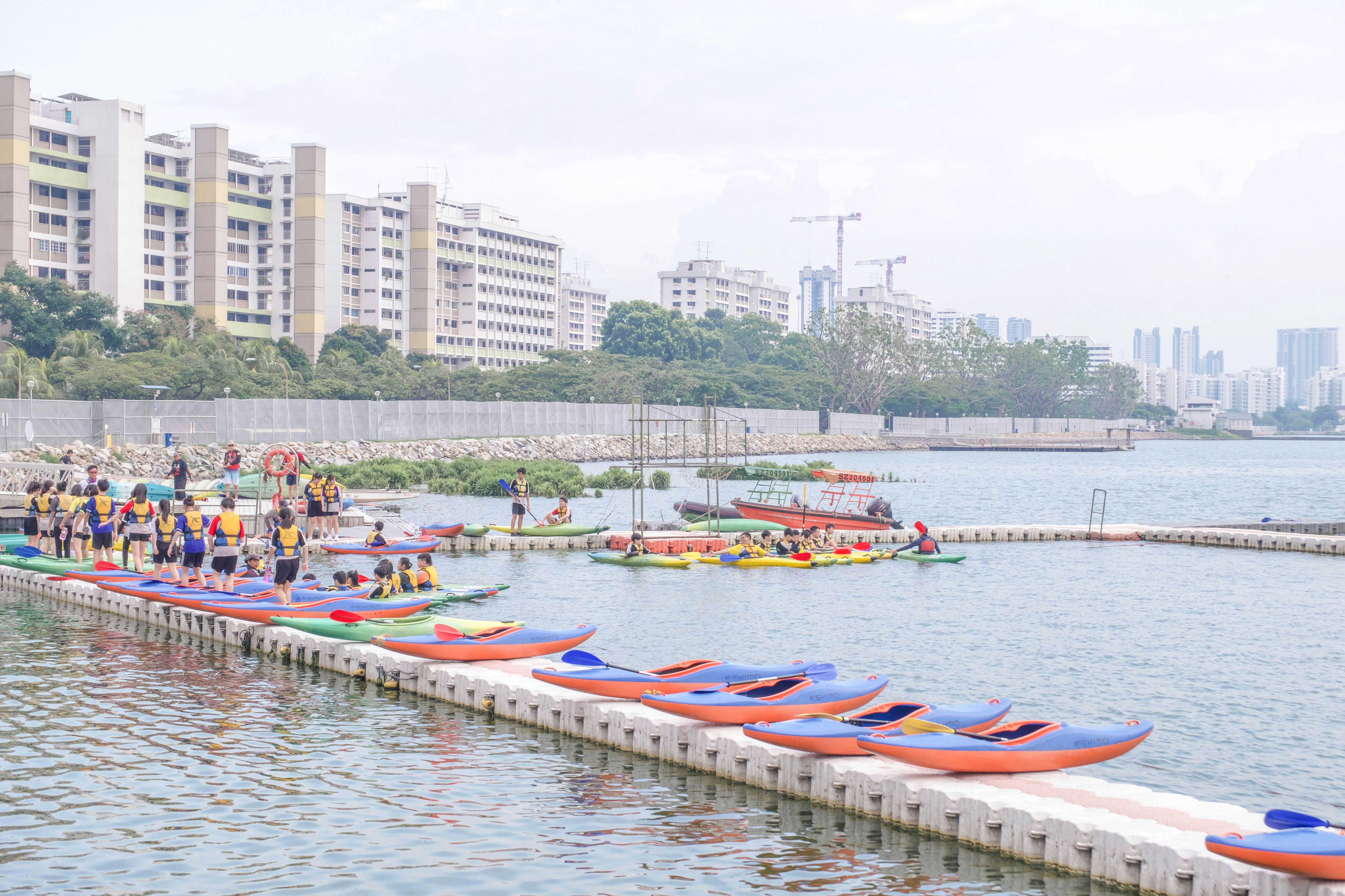 people riding on kayaks on body of water during daytime