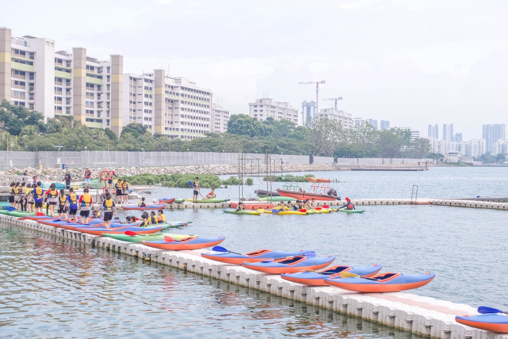 people riding on kayaks on body of water during daytime