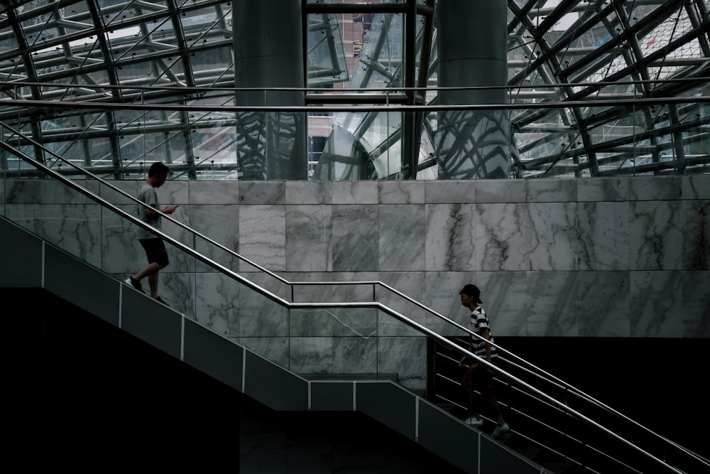 man in black shirt standing on black staircase