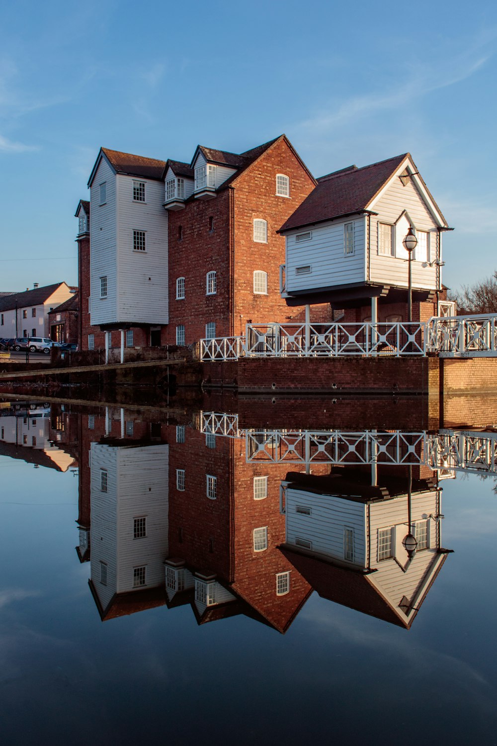 brown and white concrete building beside body of water during daytime