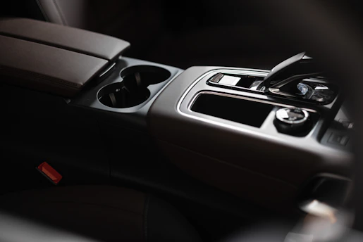 A sleek, compact mini trash bin designed for car use, fitting perfectly between seats.