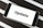 A smartphone displaying the word 'Update' on its screen is placed on a black and white striped surface. The phone is in landscape orientation, and the image focuses on the screen’s content.
