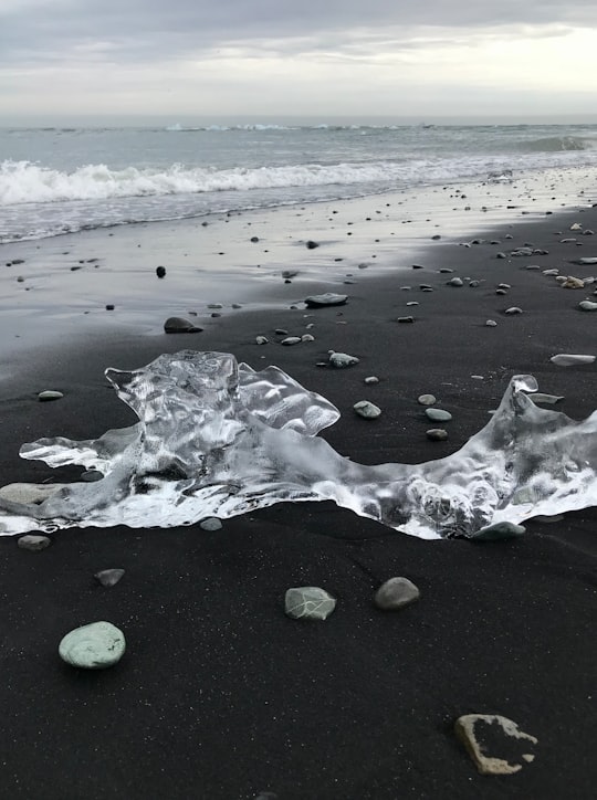 white and black stones on black sand beach in Sveitarfélagið Hornafjörður Iceland