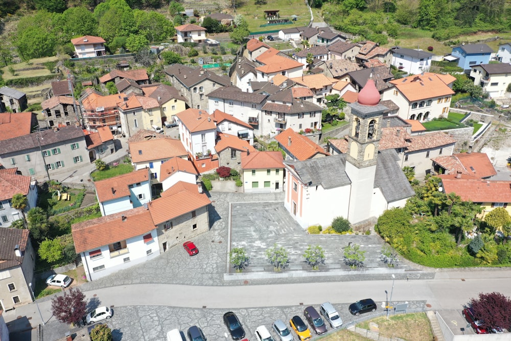 cars parked on parking lot near houses during daytime