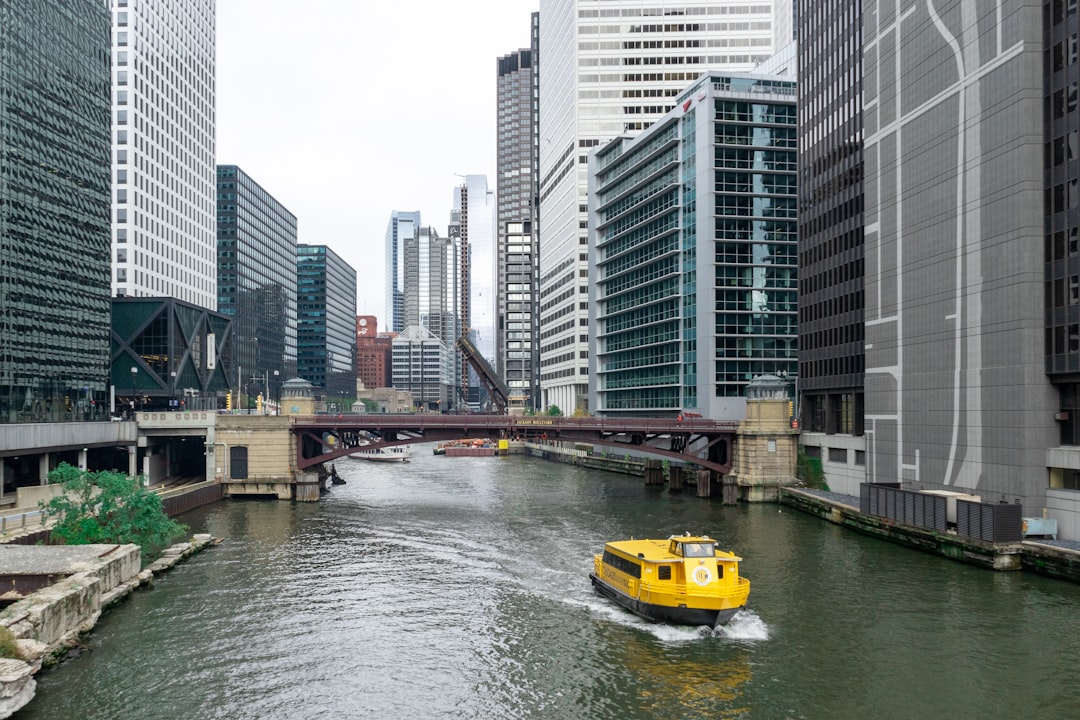 yellow boat on river near city buildings during daytime