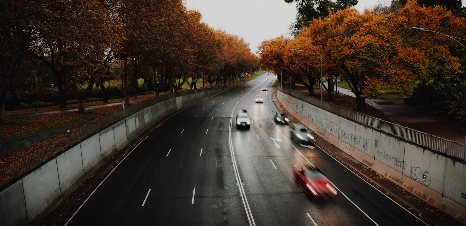 A car passes modern buildings in an Australian city