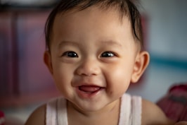 child in white tank top