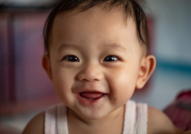 child in white tank top