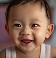 child in white tank top