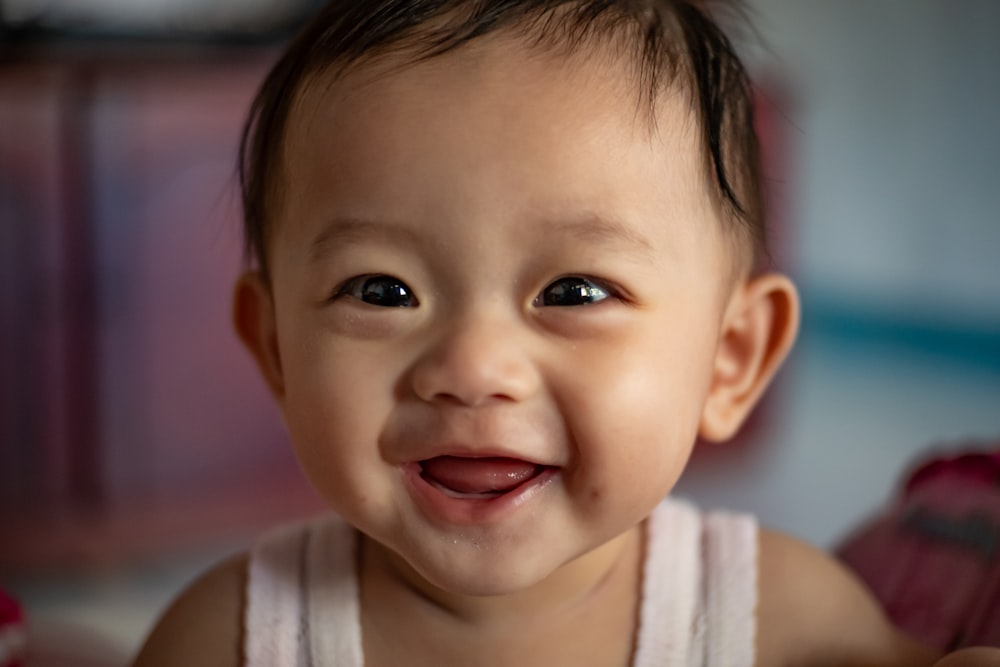 child in white tank top