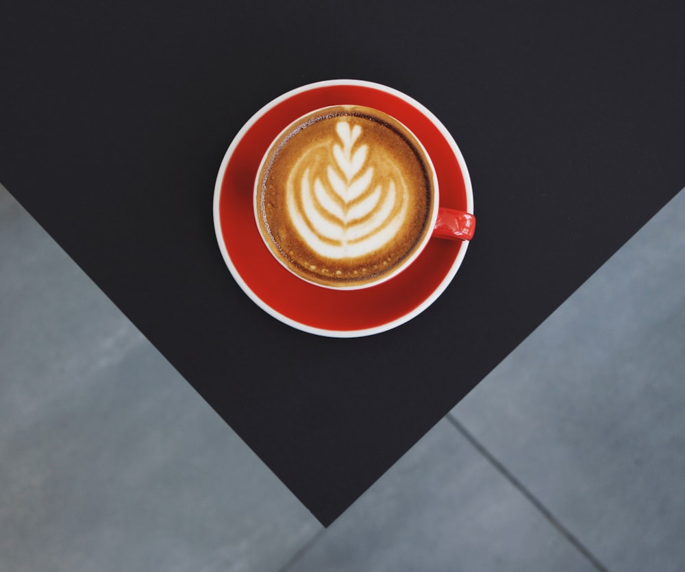 red and white ceramic mug with coffee