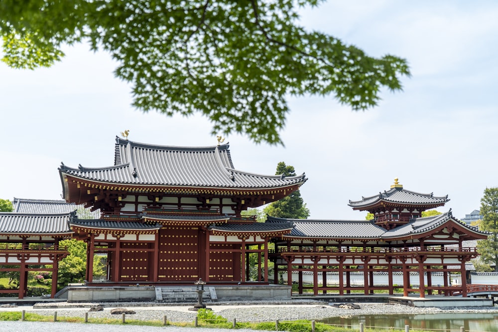 red and white temple near green trees during daytime