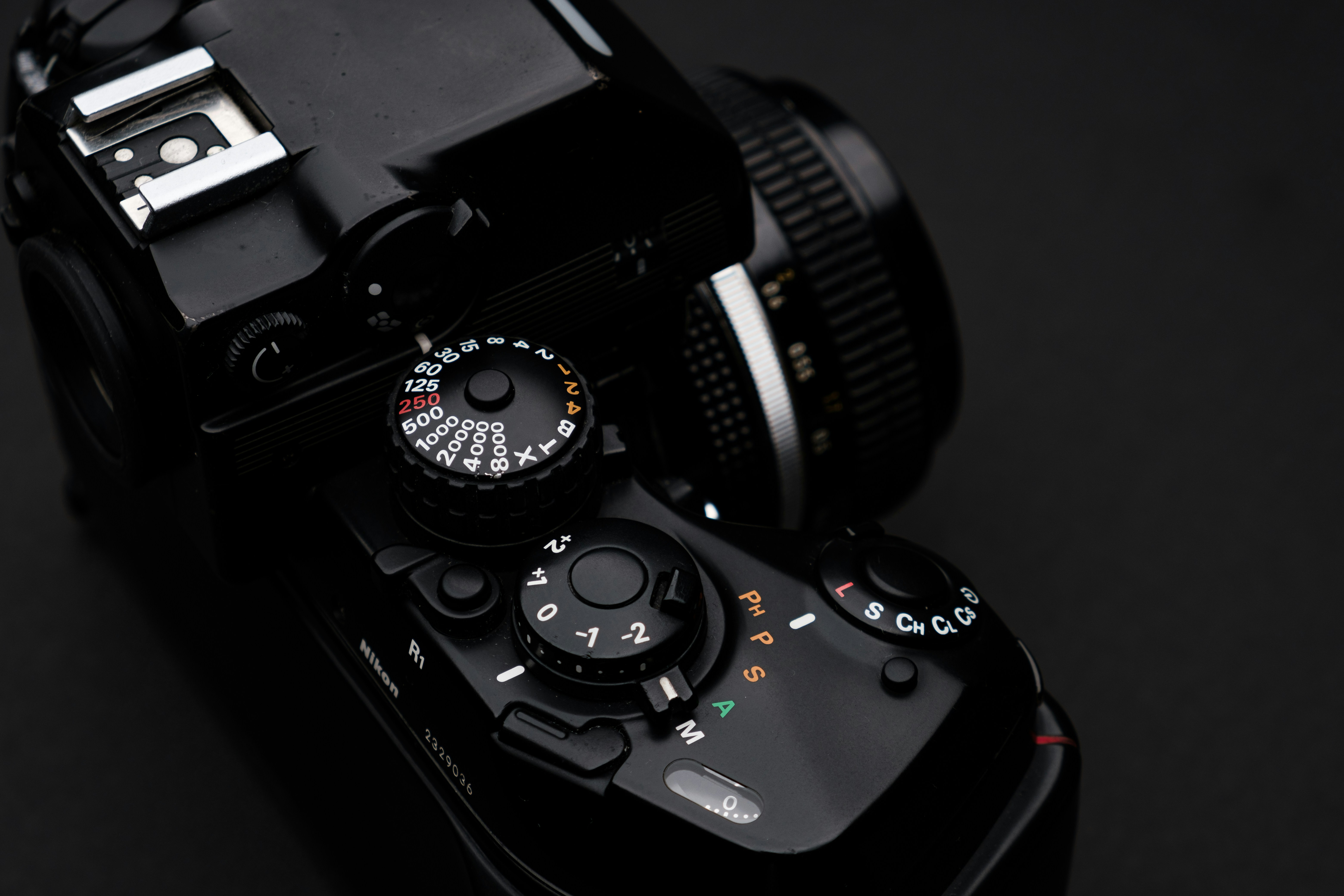 black dslr camera on black surface