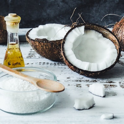 white powder in clear glass jar beside brown wooden spoon