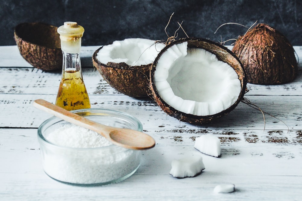 white powder in clear glass jar beside brown wooden spoon