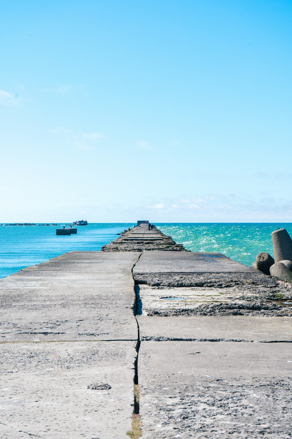 gray concrete dock near body of water during daytime