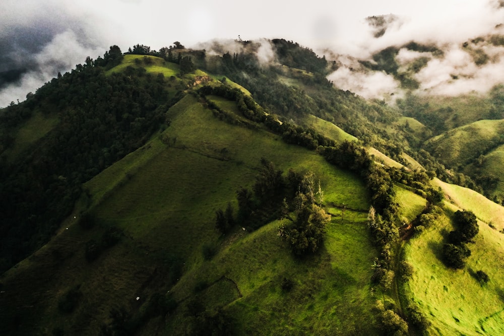 green mountain under white clouds during daytime