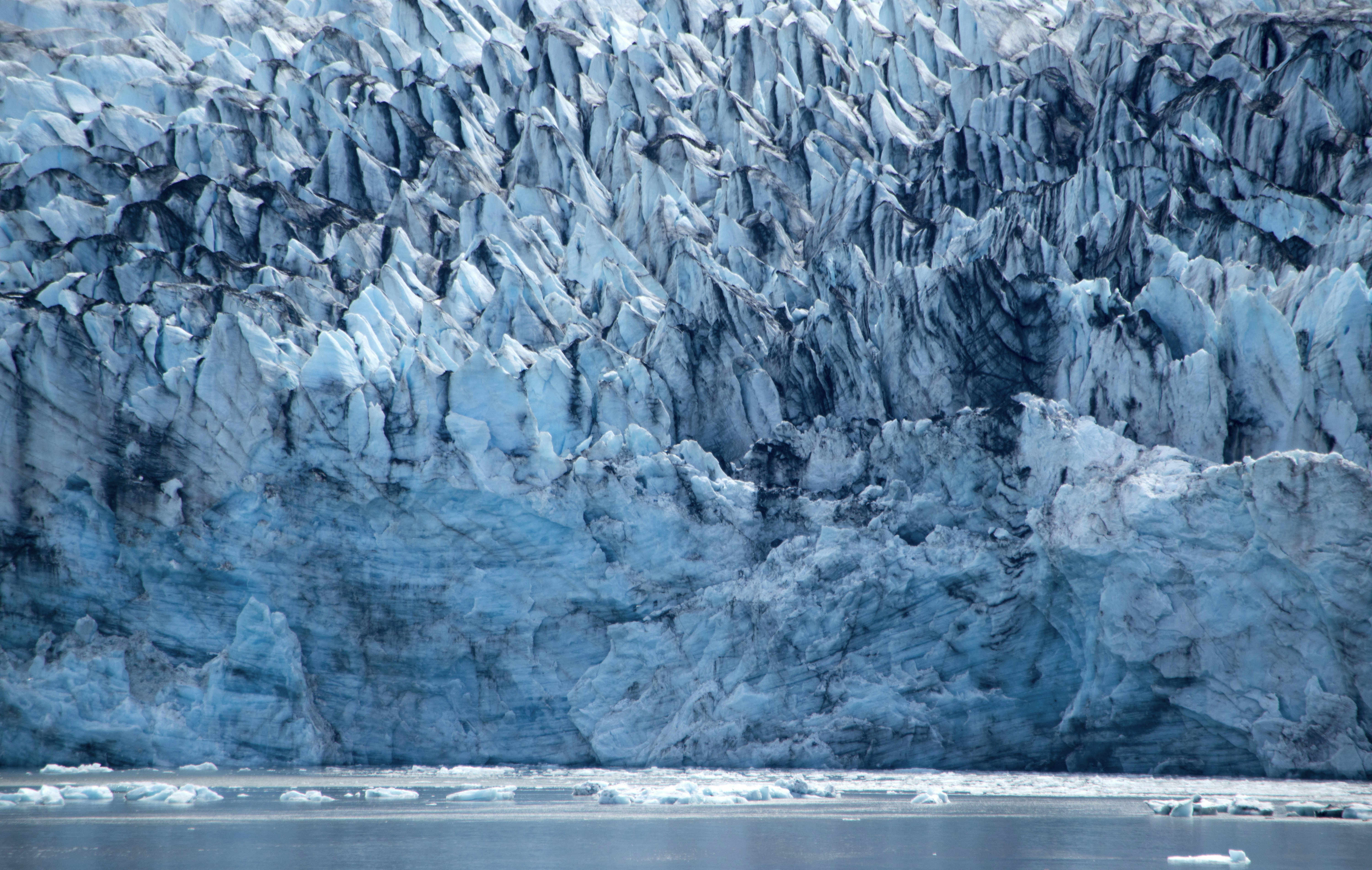gray rock formation near body of water during daytime, Glaciers in Alaska