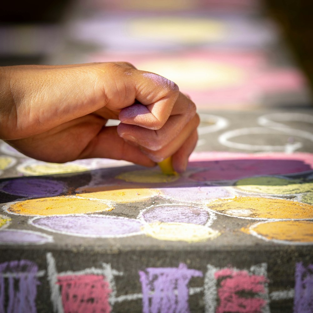 person holding purple and white textile