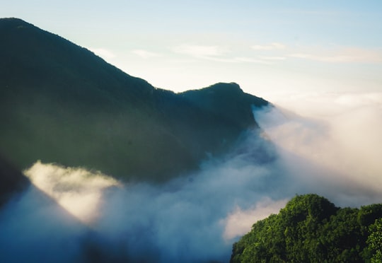 green mountain under white clouds during daytime in Madeira Portugal