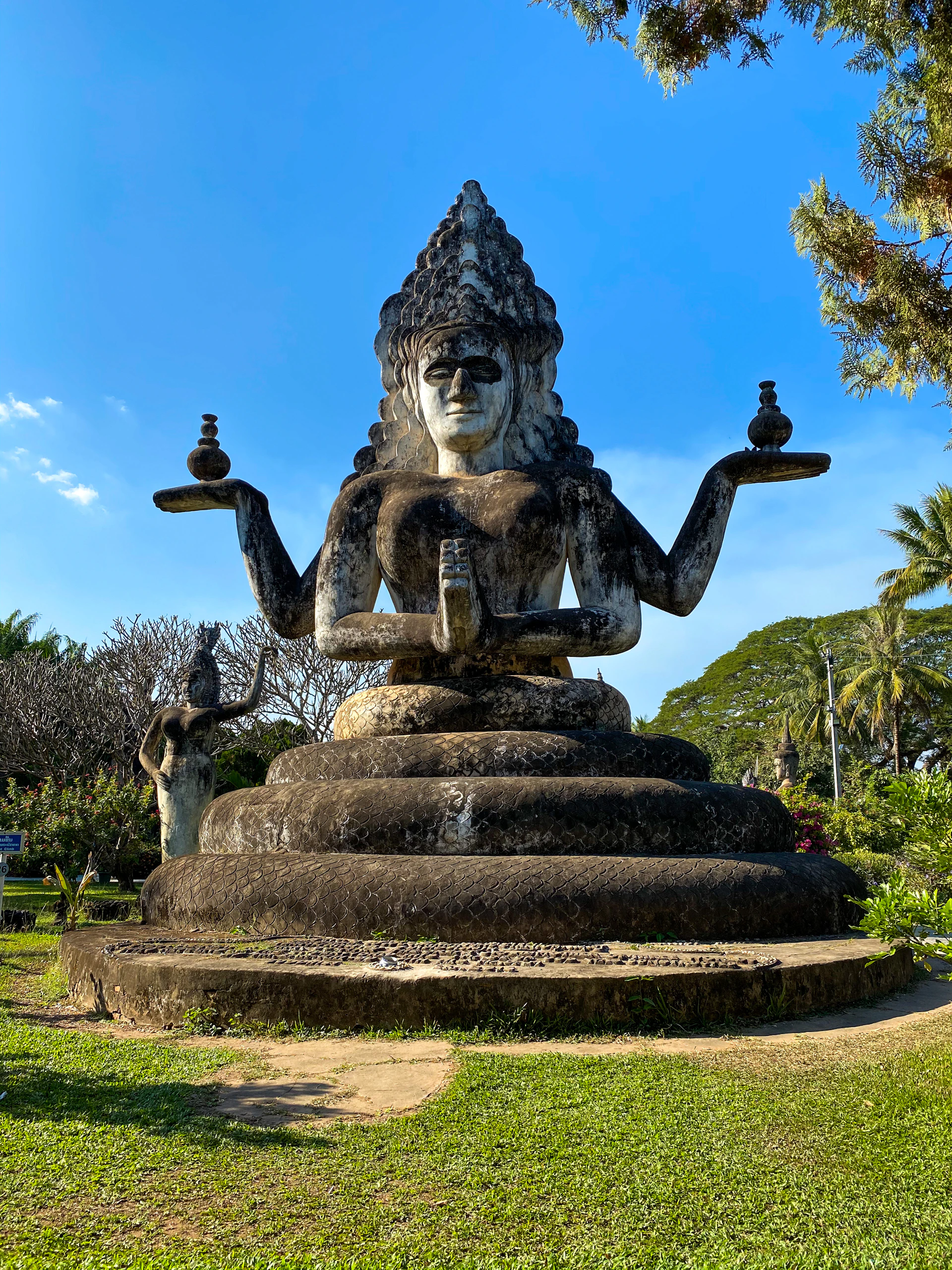black concrete statue on green grass field during daytime