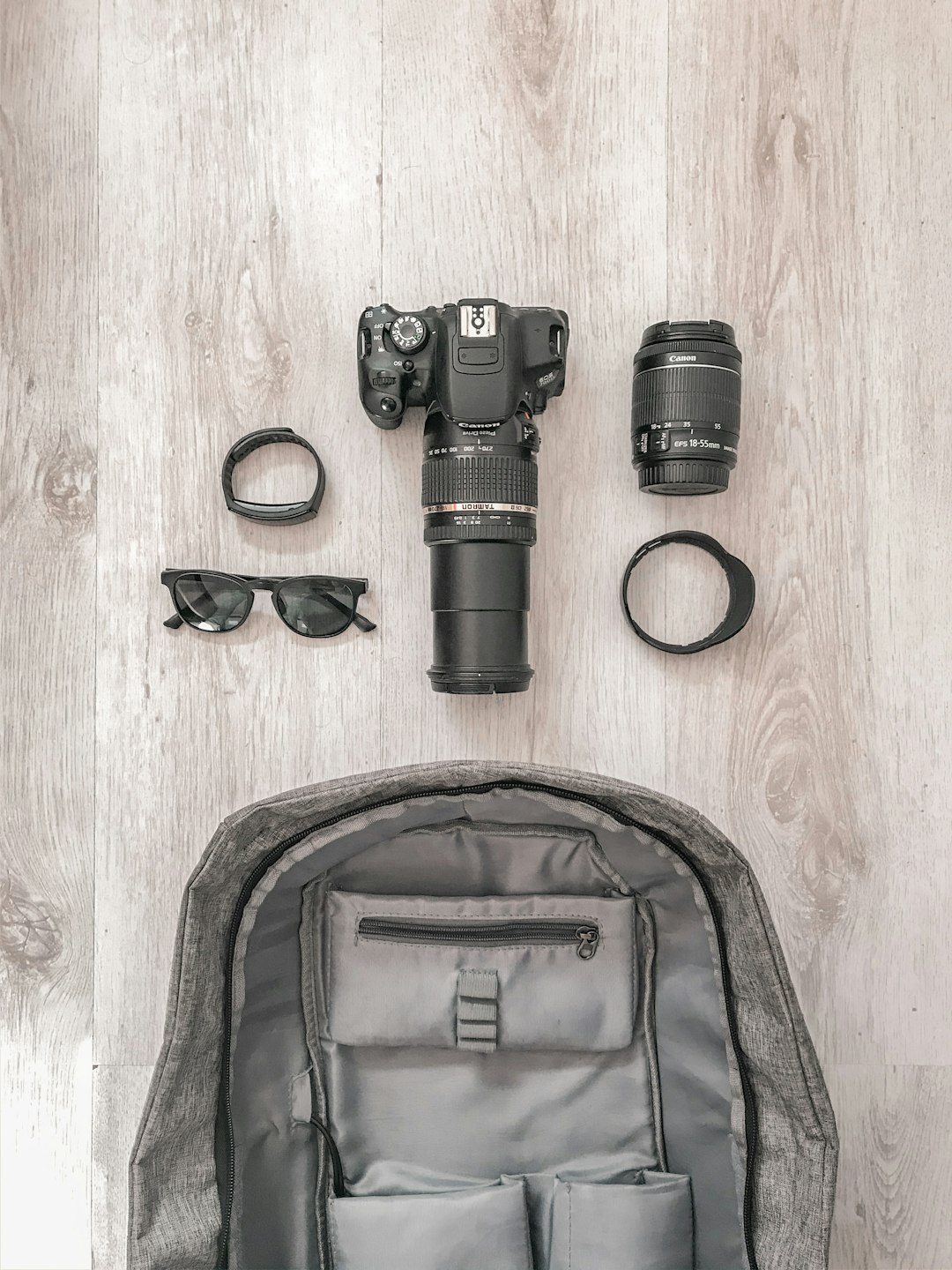 black dslr camera beside brown leather bag