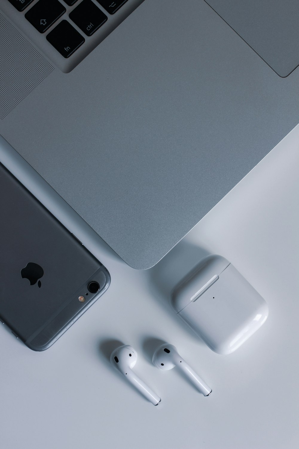 silver macbook beside white apple magic mouse