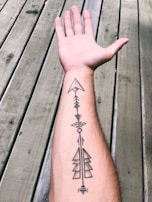 black tattoo on persons left hand