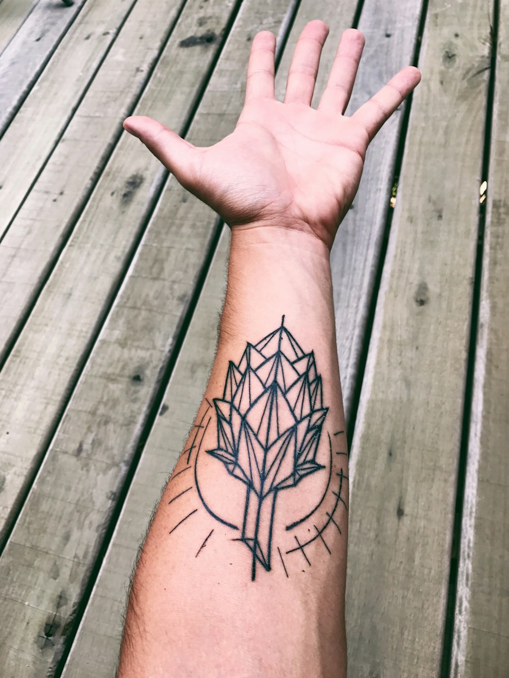 black and red flower tattoo on right human hand