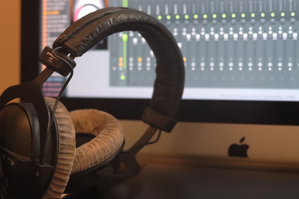 black and white headphones on brown wooden table