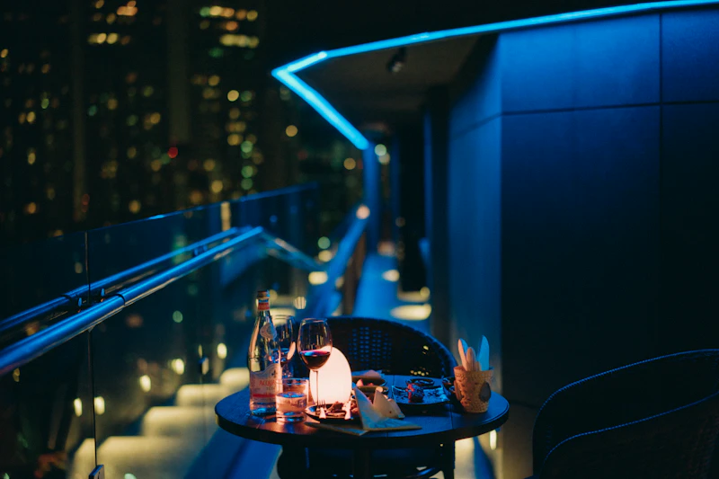 Candlelit dinner table on a Bangkok riverside terrace
