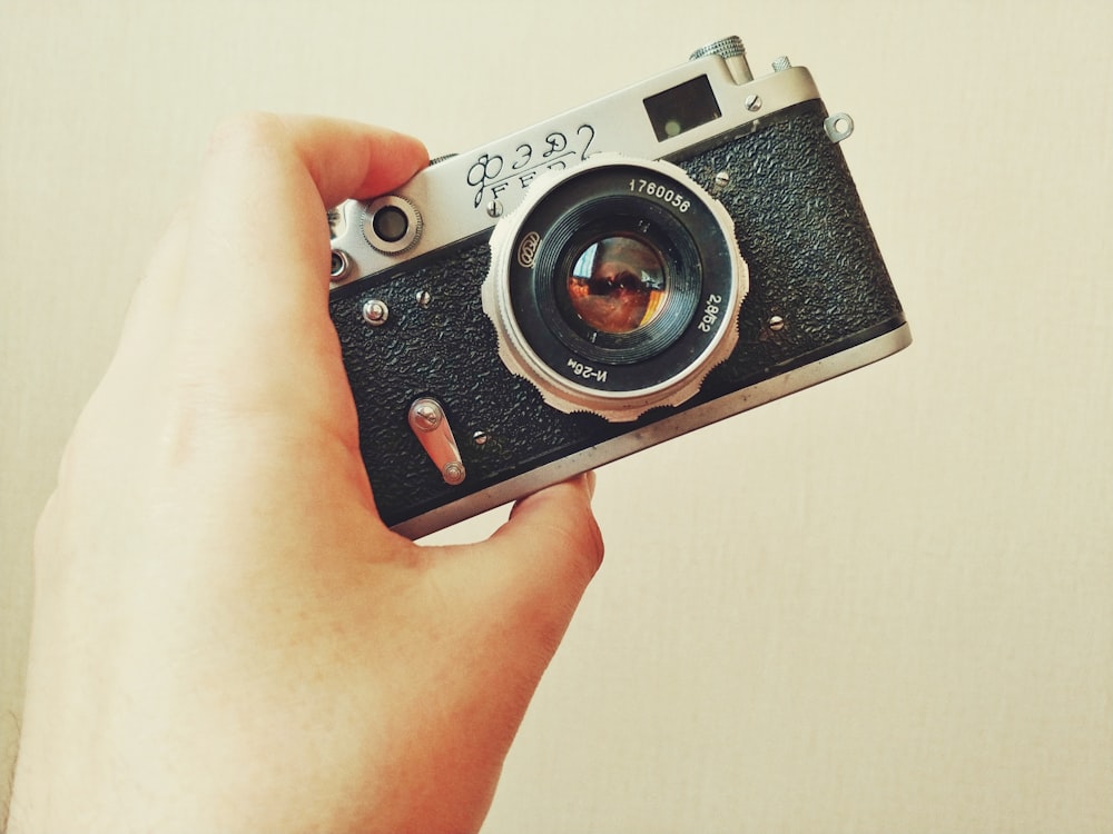 silver and black point and shoot camera