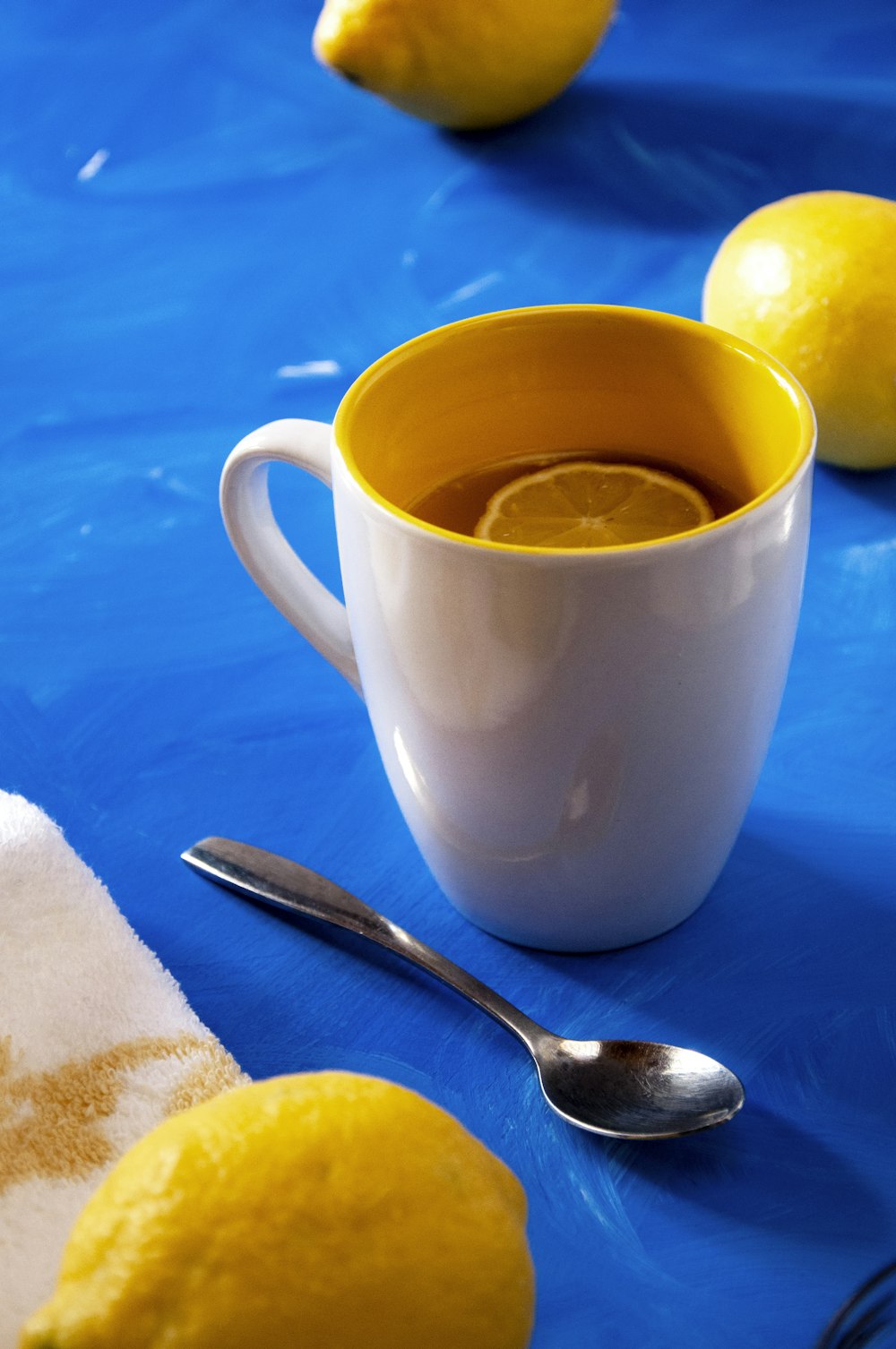 white ceramic mug with yellow liquid inside