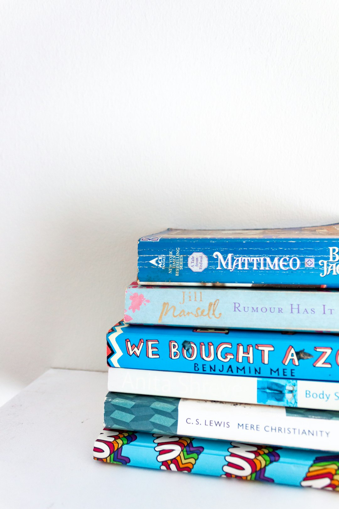 blue and green books on white table