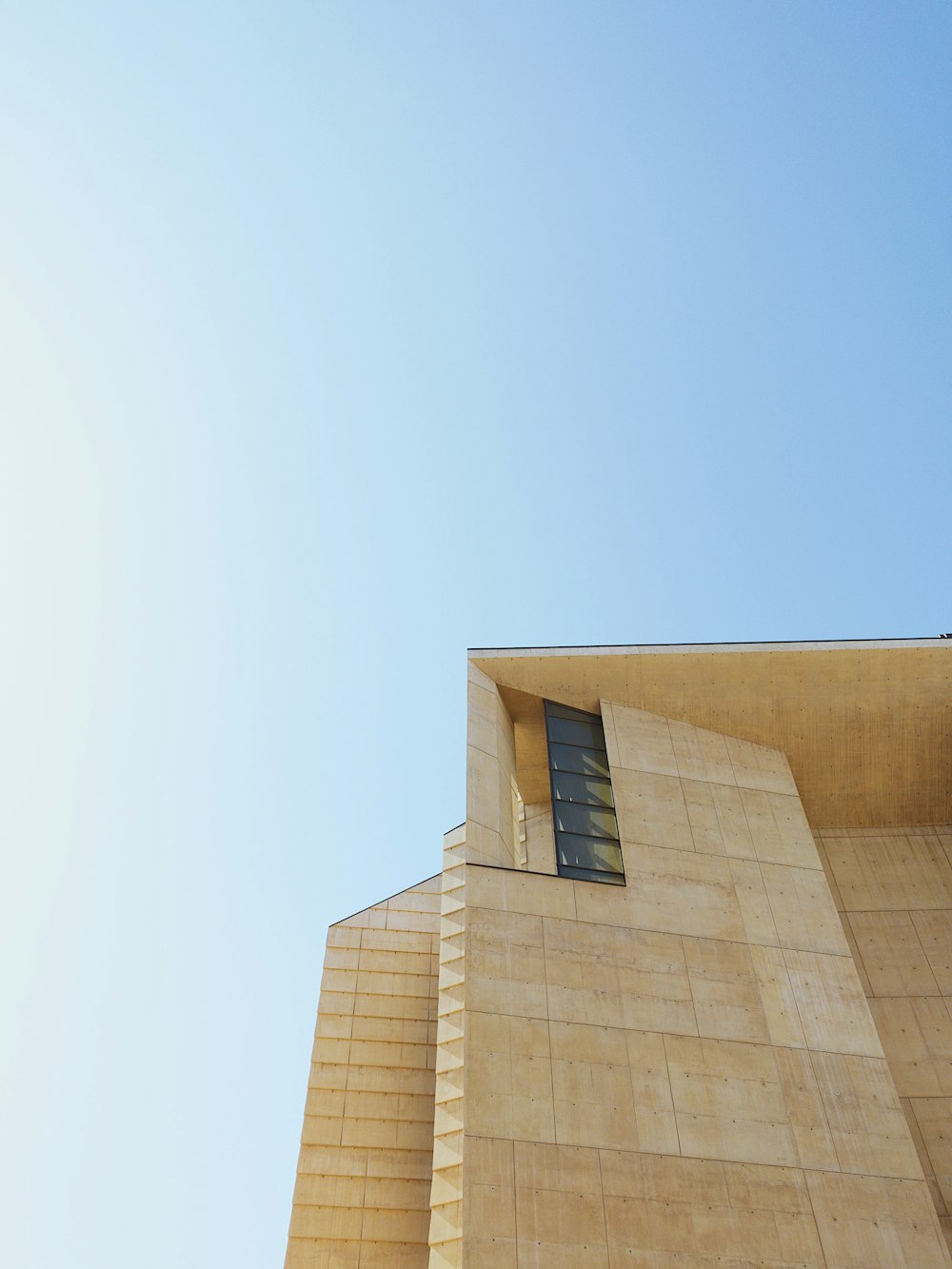 brown concrete building under blue sky during daytime