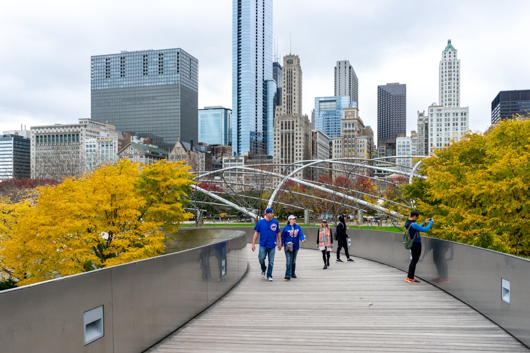 people walking on sidewalk near high rise buildings during daytime