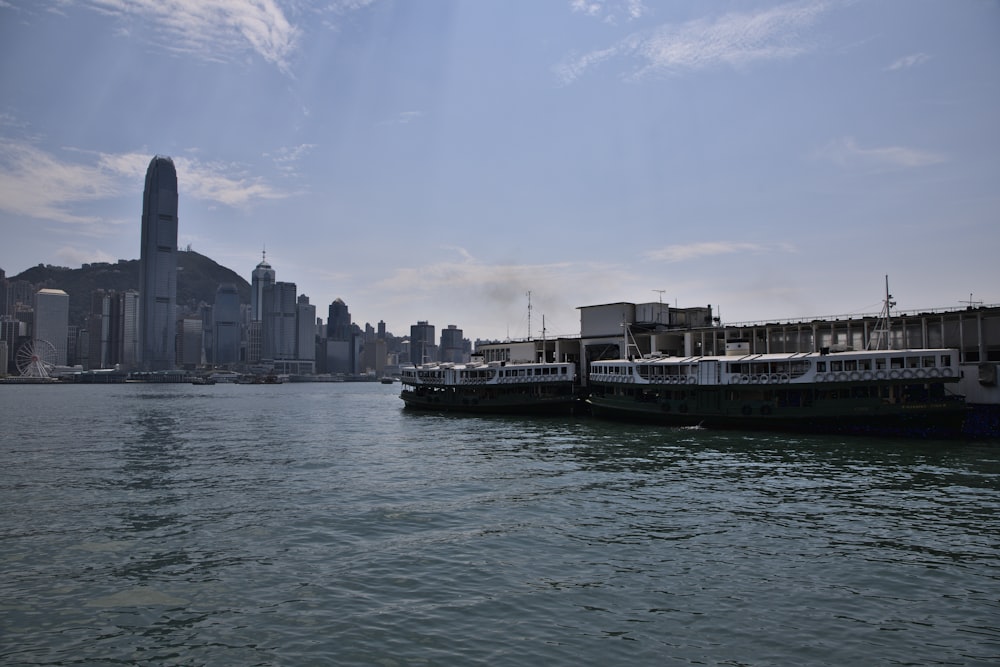 white and black boat on water near city buildings during daytime