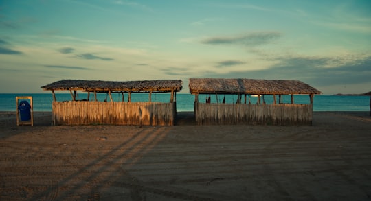 brown wooden dock under cloudy sky during daytime in Cabo de La Vela Colombia