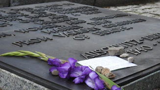 Close-up of a sleek black and white memorial plaque with a QR code on a gravestone