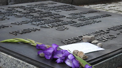 Close-up of a sleek black and white memorial plaque with a QR code on a gravestone