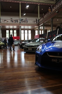 Attendees exchanging business cards and smiling warmly at the still just cars conference.