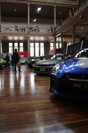 Attendees exchanging business cards and smiling warmly at the still just cars conference.