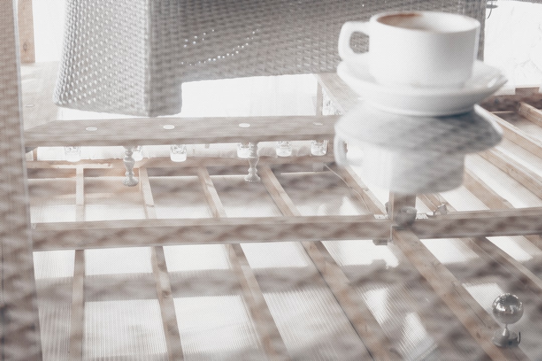 white ceramic teacup on brown wooden table