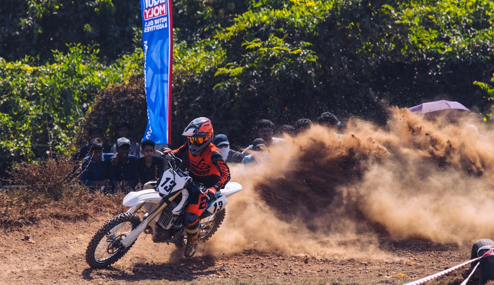 man in red and white motocross helmet riding motocross dirt bike