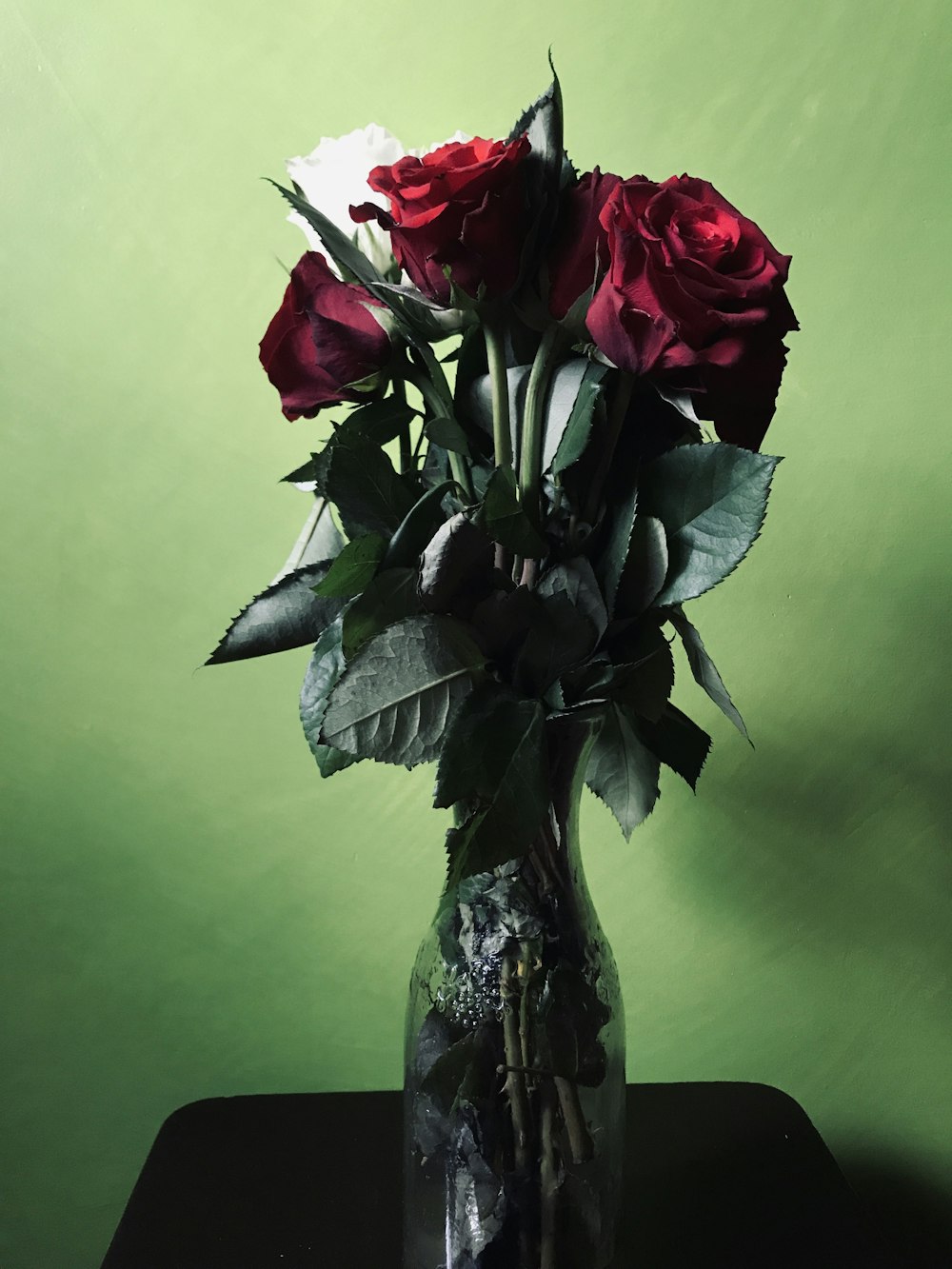 red roses in clear glass vase